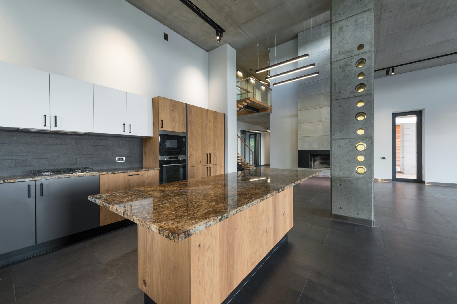 Kitchen with granite-topped oak island and concrete features